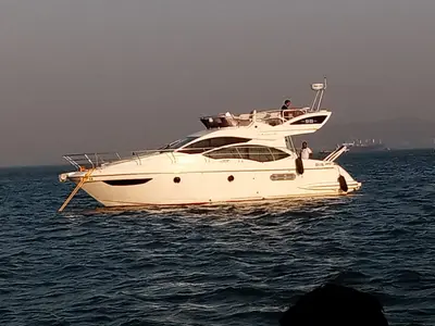 The Azimut 38 motor yacht at anchor off Mumbai at golden hour
