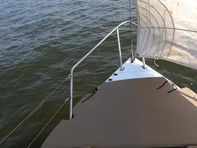 Feeling Nauti's bow under sail with the Mumbai coastline behind